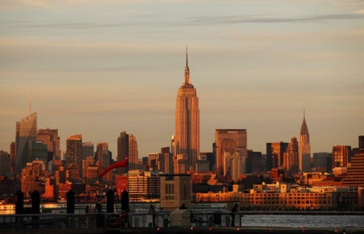 The Empire State Building sits between the Bank of America building and the Chrysler Building at sunset in New York