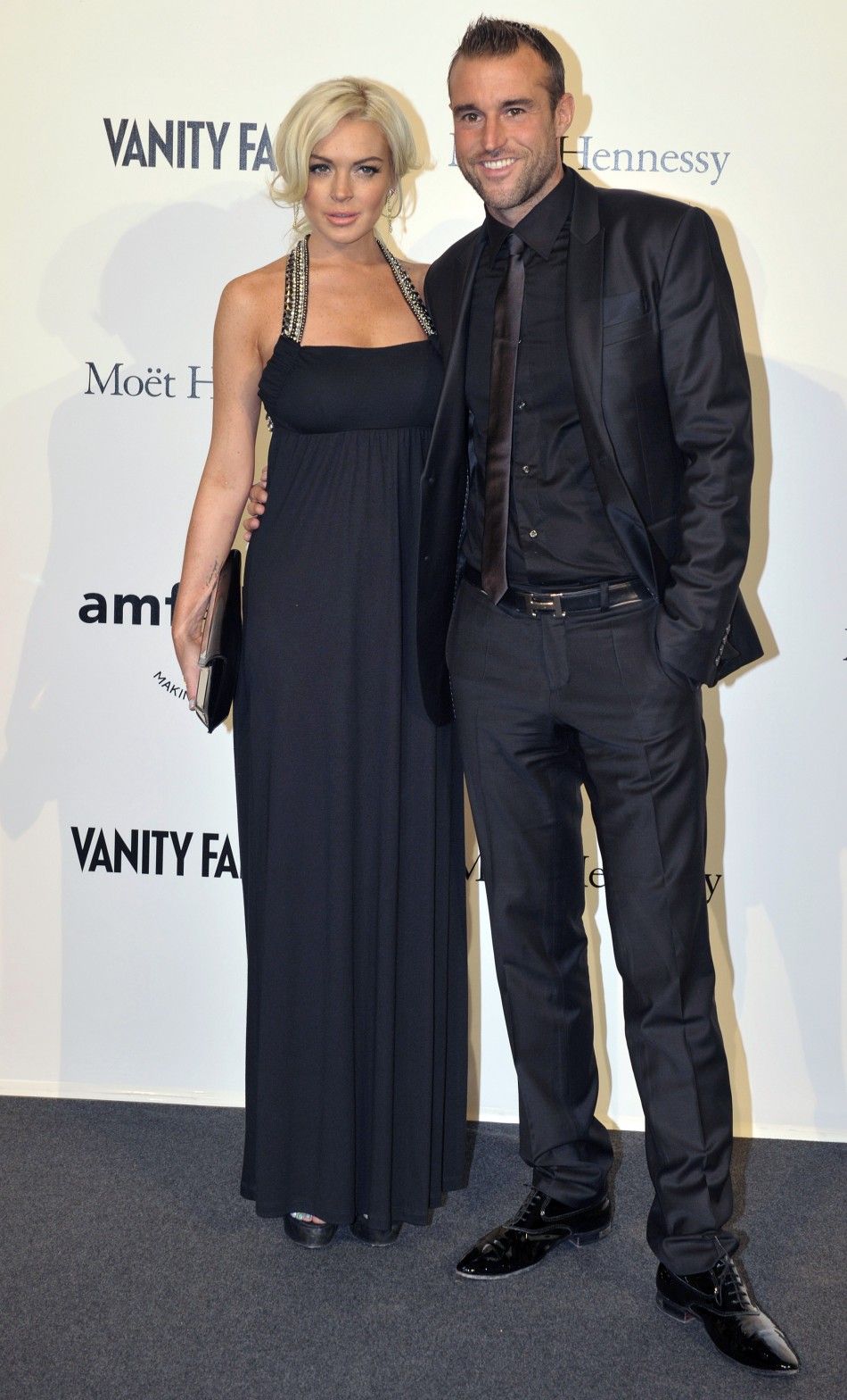 Actress Lindsay Lohan and designer Philippe Plein arrive at the amfARs Milan Fashion Week Gala in Milan
