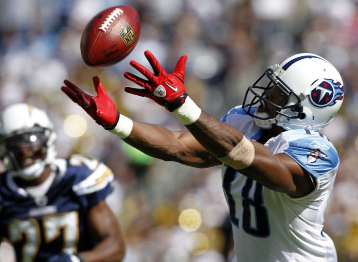 Tennessee Titans Kenny Britt reaches out, as San Diego Chargers safety Paul Oliver watches, in their NFL football game in San Diego