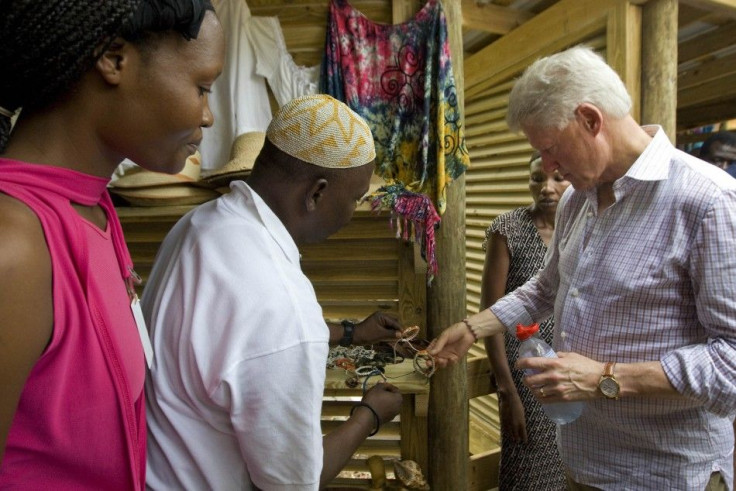 U.S. President Bill Clinton (R) shops for Haitian style bracelets while at Labadie resort near the northern city of Cap Haitian during his two day trip to promote tourism and industry in Haiti
