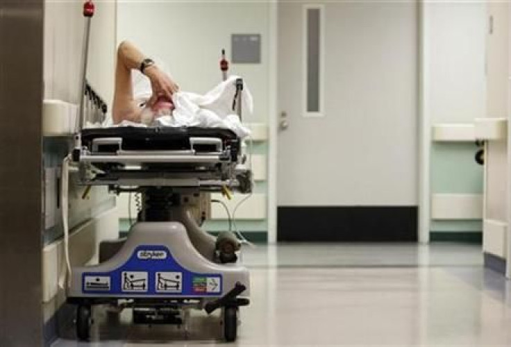 A patient waits in the hallway for a room to open up in the emergency room at Ben Taub General Hospital in Houston, Texas