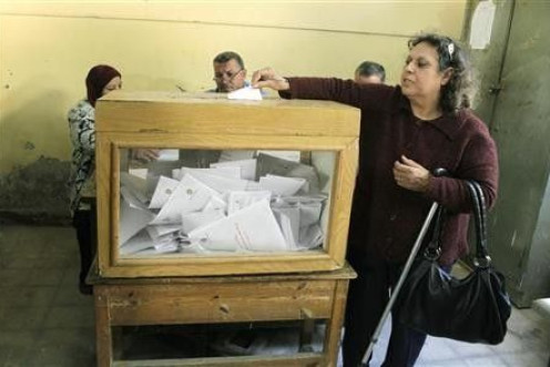 An Egyptian woman casts her vote during a national referendum at a school in Cairo