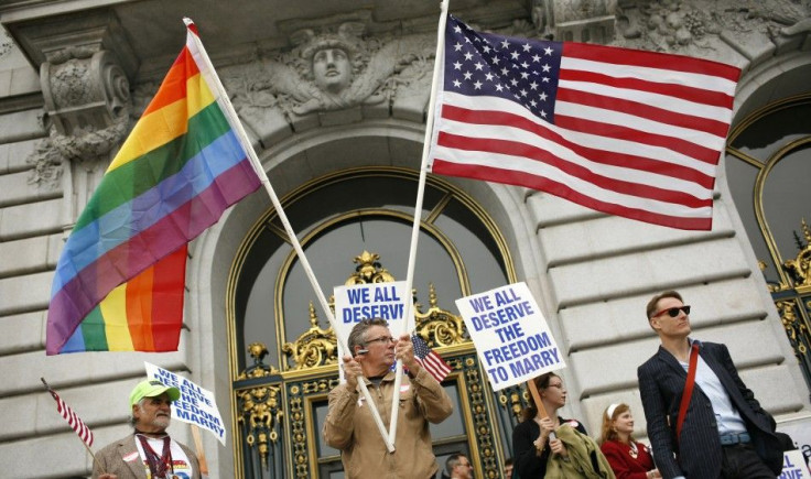 Billy Bradford waves flags outside City Hall after a judge lifted the Proposition 8 stay on same sex marriages at City Hall in San Francisco