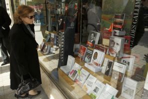 A woman looks in a bookstore window in Tunis