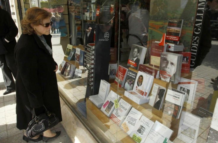 A woman looks in a bookstore window in Tunis
