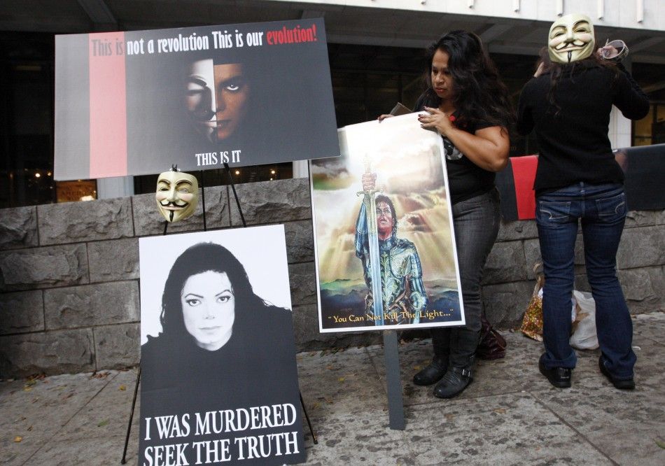 Divina Baham and Sam Ivanova set up placards during the opening day of Dr. Conrad Murray039s trial in the death of pop star Michael Jackson in Los Angeles