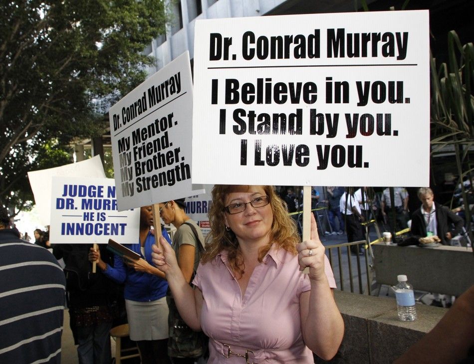 Stacy Ruggles holds a sign during the opening day of Murray039s trial in the death of pop star Michael Jackson in Los Angeles