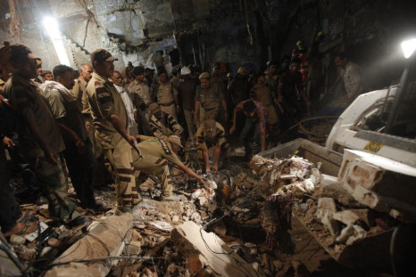 rescue and workers and search and for and survivors and under and the and rubble and collapsed and building and the and old and quarters and delhi and september and 28 and 2011.