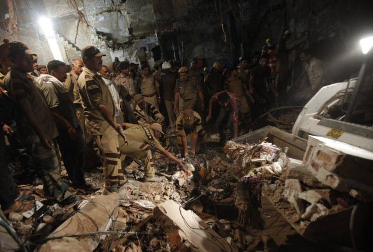 rescue and workers and search and for and survivors and under and the and rubble and collapsed and building and the and old and quarters and delhi and september and 28 and 2011.