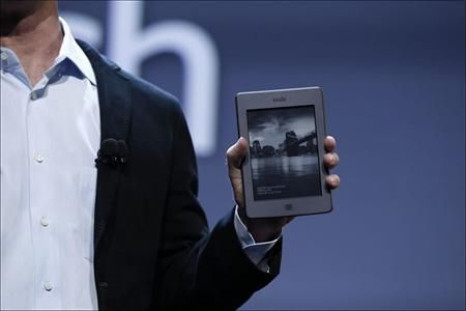 Amazon CEO Jeff Bezos holding the Kindle Touch during the launch of Amazon's new tablet in New York