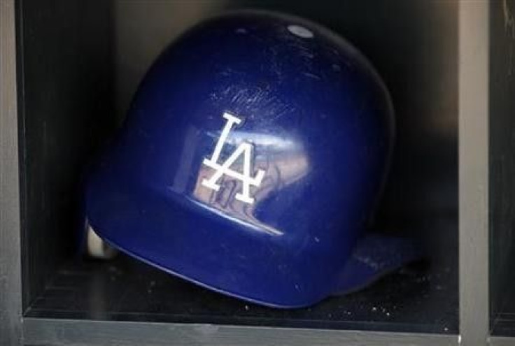 A batting helmet reflects the dugout of the Los Angeles Dodgers before the start of the Dodgers' American League baseball game against the Minnesota Twins at Target Field in Minneapolis