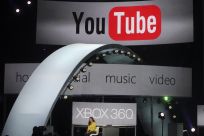A woman demonstrates YouTube services on the Xbox game console at the Microsoft E3 XBOX 360 press briefing in Los Angeles