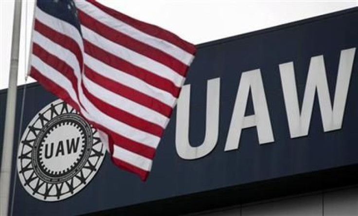An American flag flies in front of the United Auto Workers union logo