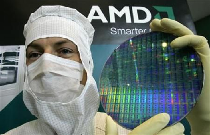 A technician of computer microprocessors maker AMD poses for the media with a wafer at the chip plant in Dresden