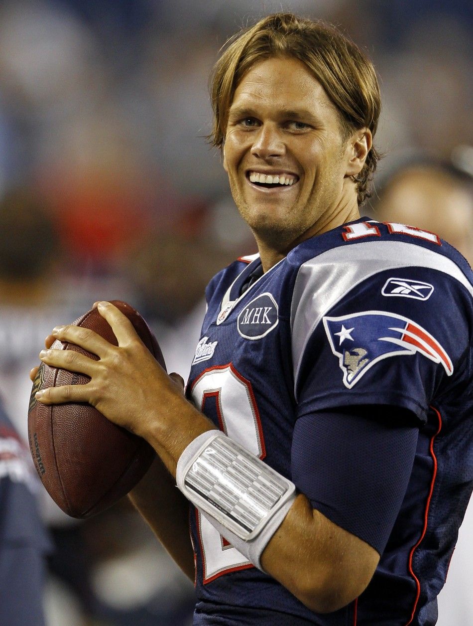 New England Patriots quarterback Tom Brady laughs on the sideline against the New York Giants during the second half of their NFL football game in Foxborough, Massachusetts September 1, 2011.