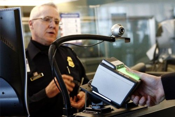 A traveler has his fingerprints scanned at the international travel entry point at JFK International Airport in New York