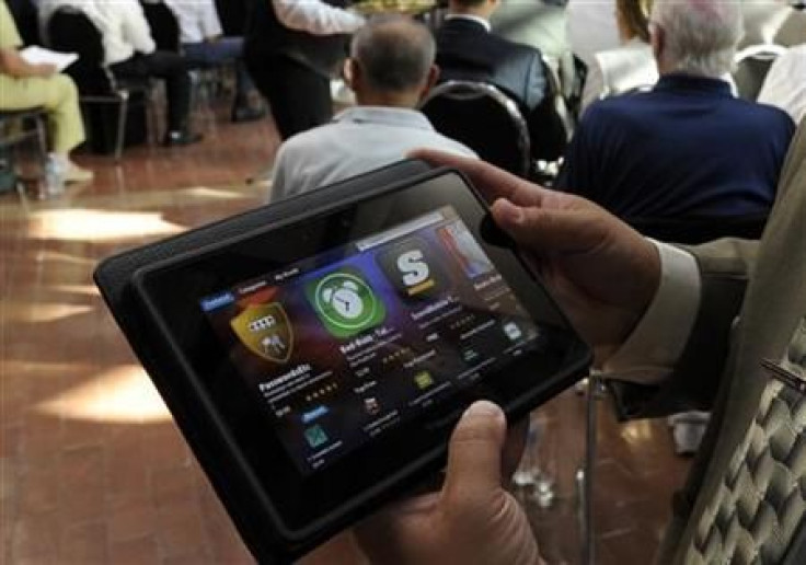 A man holds a BlackBerry PlayBook during the RIM annual general meeting of shareholders in Waterloo