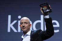 Amazon CEO Bezos holds up new Kindle Fire tablet at news conference in New York
