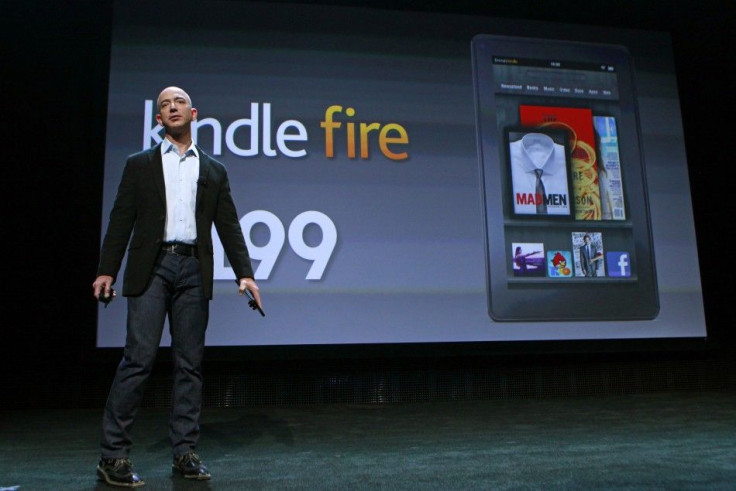 Jeff Bezos demonstrates the new Kindle Fire tablet as he speaks at a news conference during the launch of Amazon's new tablets in New York