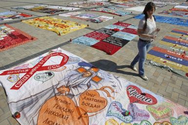 A woman looks at quilts, created by HIV-positive people, on display during the &quot;Names&quot; event in Mikhailovskaya square