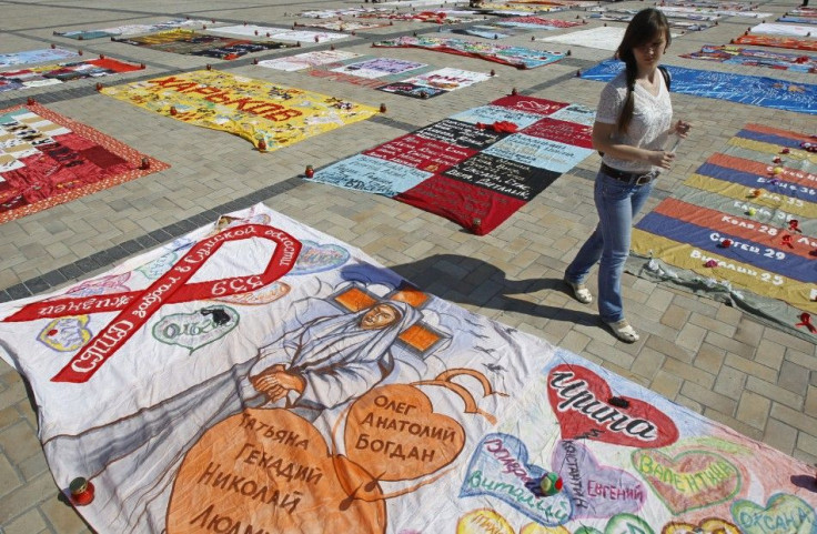 A woman looks at quilts, created by HIV-positive people, on display during the &quot;Names&quot; event in Mikhailovskaya square