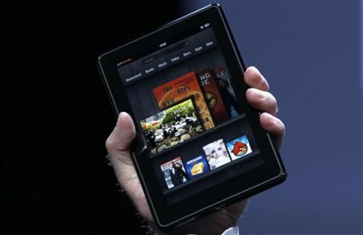 Jeff Bezos holds up the new Kindle Fire at a news conference during the launch of Amazon's new tablets in New York