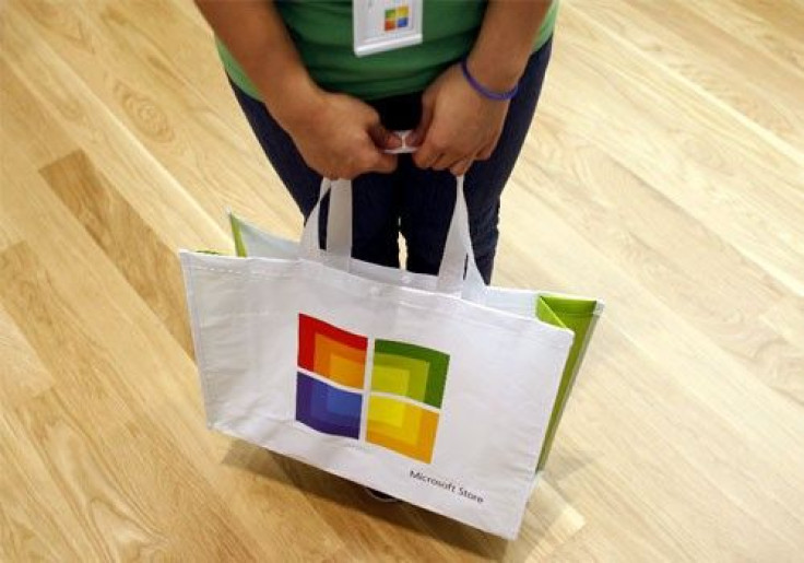 A worker holds a bag during the grand opening of Microsoft's first retail store in Scottsdale, Arizona