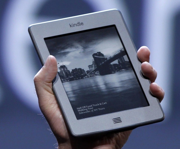 Amazon CEO Jeff Bezos holds up the new Kindle Touch. If Amazon buys Palm, the Kindle, Kindle Touch, and Kindle Fire could all run on an enhanced version of webOS.