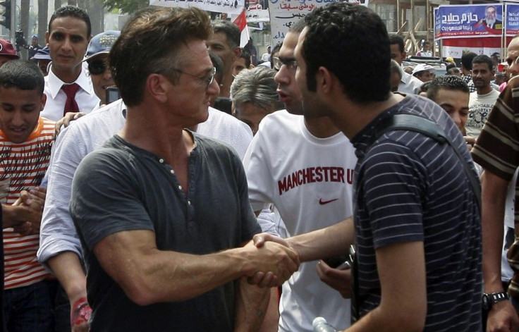 U.S. actor and director Sean Penn shakes hands with protesters in Tahrir Square