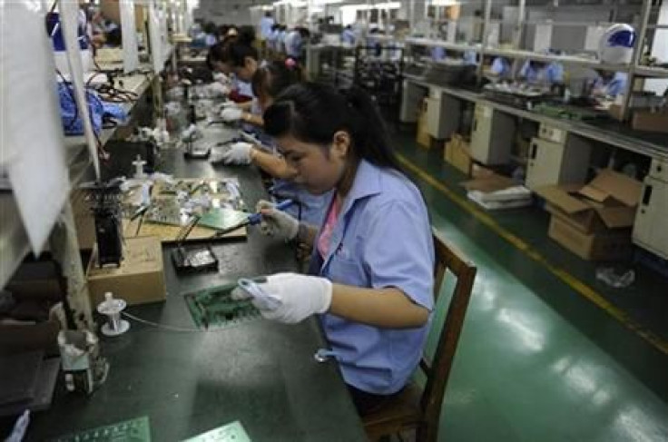 An employee works on circuit boards at an electronic component factory in Hefei