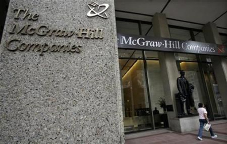 A woman walks past the entrance to offices of the McGraw-Hill Companies, in New York