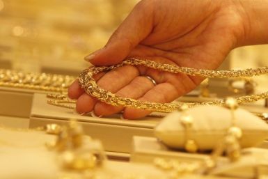 An employee displays a gold necklace during a photo opportunity at the Ginza Tanaka store in Tokyo September 17, 2010.  