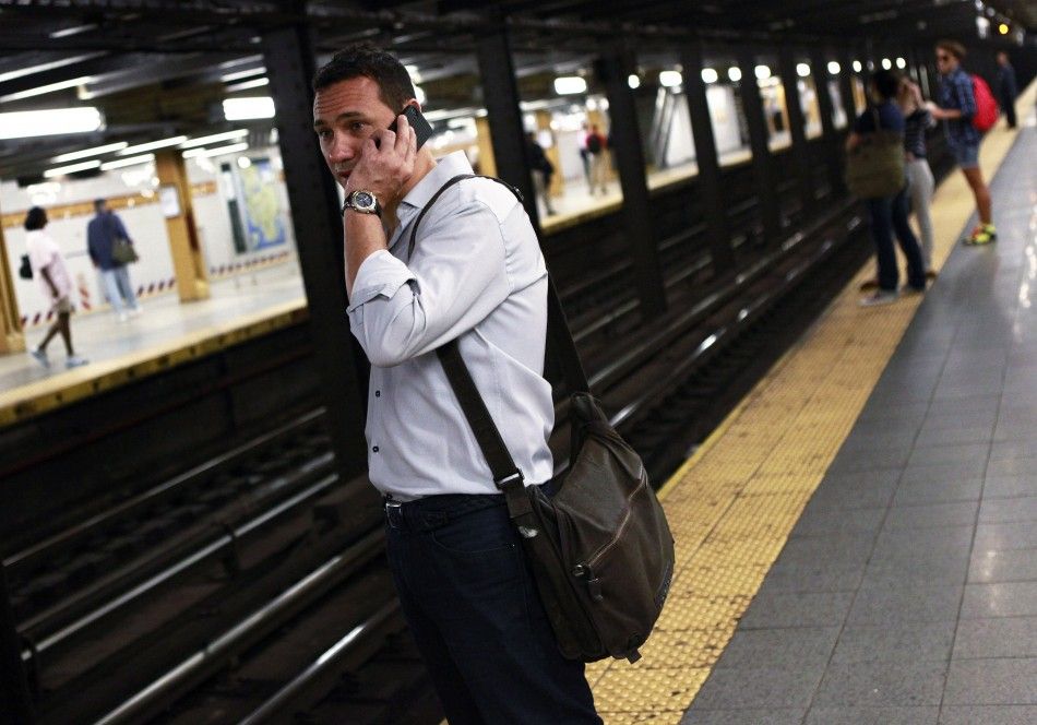 Giuseppe Castellano uses his ATT iPhone in the subway at West 14th Street and 8th Avenue in New York