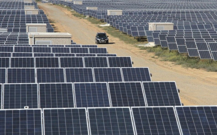 A car drives along the territory of a solar energy power station near the Okhotnikovo village in the Crimea's Saksky district