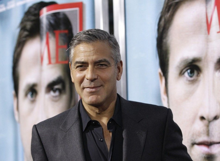 Director and cast member George Clooney poses at the premiere of "The Ides of March" at the Samuel Goldwyn theatre in Beverly Hills, California