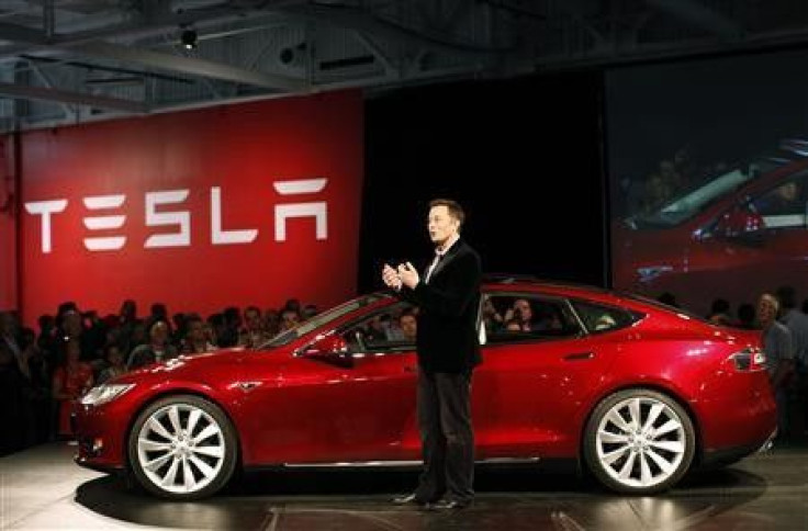 Tesla Motors CEO Elon Musk speaks next to the comany's newest Model S during the Model S Beta Event held at the Tesla factory in Fremont, California