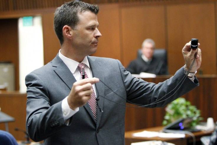 Deputy District Attorney David Walgren holds a monitoring device introduced as evidence as he questions Alberto Alvarez, one of Michael Jackson's security guards, during Dr. Conrad Murray's trial in the death of pop star Michael Jackson in Los Angeles 