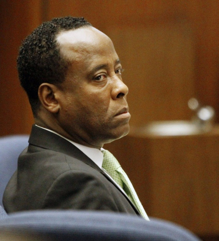 Dr. Conrad Murray watches his former patient, Robert Russell, testify during Murray's involuntary manslaughter trial in the death of pop star Michael Jackson in Los Angeles