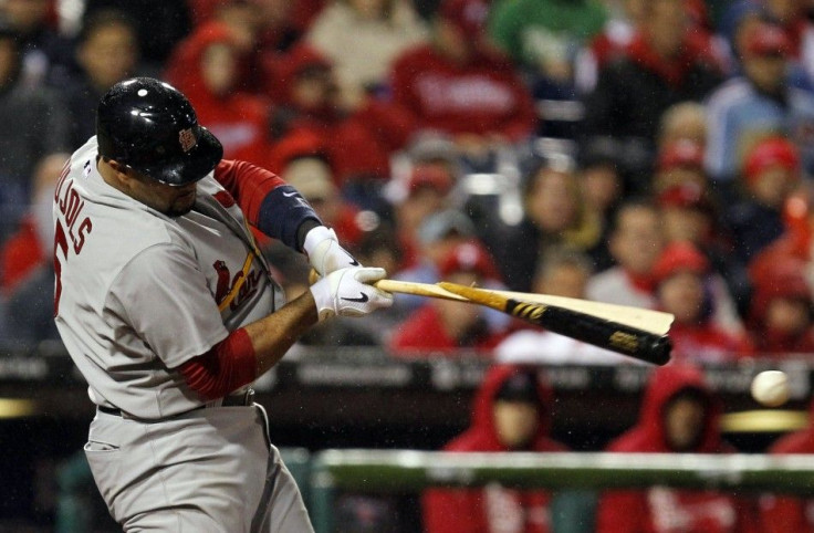 St. Louis Cardinals&#039; Albert Pujols hits a broken bat single against the Philadelphia Phillies in the ninth inning of Game 2 of their MLB National League Divisional Series baseball playoffs in Philadelphia
