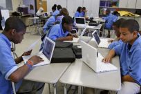 Students at the Lilla G. Frederick Pilot Middle School work on their laptops during a class in Dorchester, Massachusetts