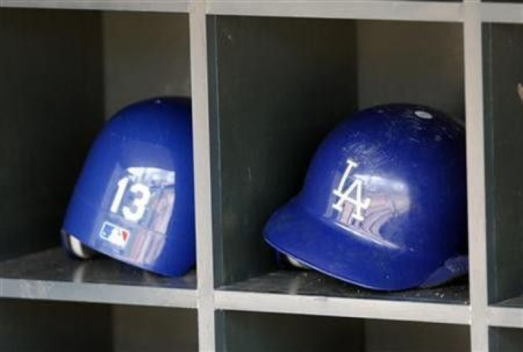 Los Angeles Dodgers batting helmets are seen in the dugout before the start of their American League MLB baseball game against the Minnesota Twins at Target Field in Minneapolis