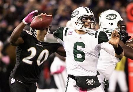Baltimore Ravens safety Ed Reed (L) comes up from behind to slap the ball from the hand of New York Jets quarterback Mark Sanchez in the first quarter of their NFL football game in Baltimore, Maryland
