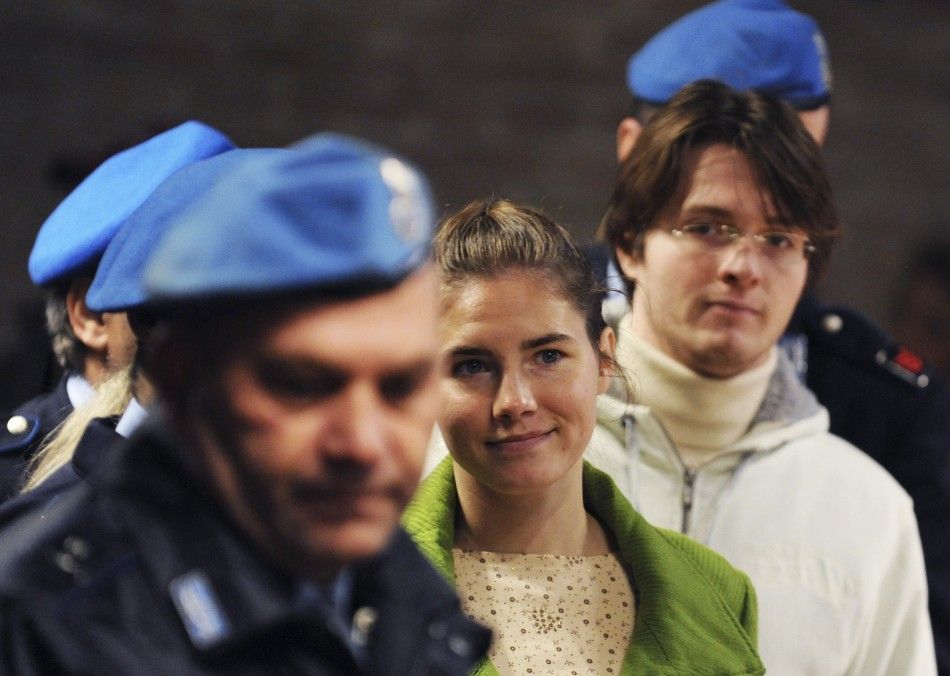 American university student Amanda Knox C and her Italian ex-boyfriend Raffaele Sollecito R are escorted into courtroom during their murder trial session in Perugia