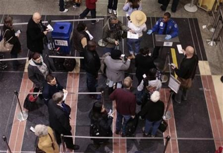 Travelers wait in line to go through TSA screening in the Ronald Reagan Washington National Airport in Arlington, Virginia