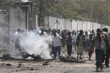 Residents gather at the scene of a suicide attack in Somalia&quot;s