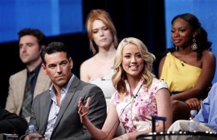 Cast member Amber Heard speaks as co-stars Eddie Cibrian (L), David Krumholtz (L back), Leah Renee Cudmore and Naturi Naughton watch during the NBC Universal session for &#039;&#039;The Playboy Club&#039;&#039; at the 2011 Summer Television Critics Associ