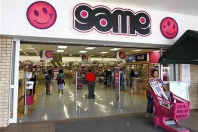 A shopper leaves a branch of Game supermarket chain in South Africa