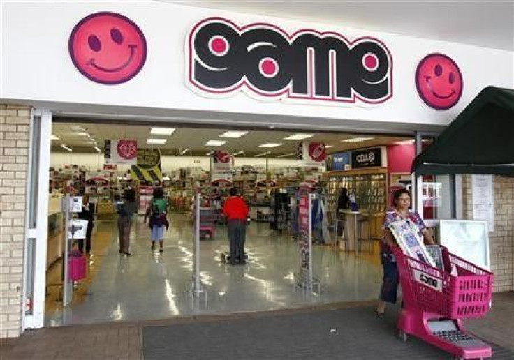 A shopper leaves a branch of Game supermarket chain in South Africa