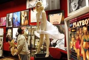 A visitor looks at a sculpture of Marilyn Monroe in the showroom of Drouot auction house in Paris