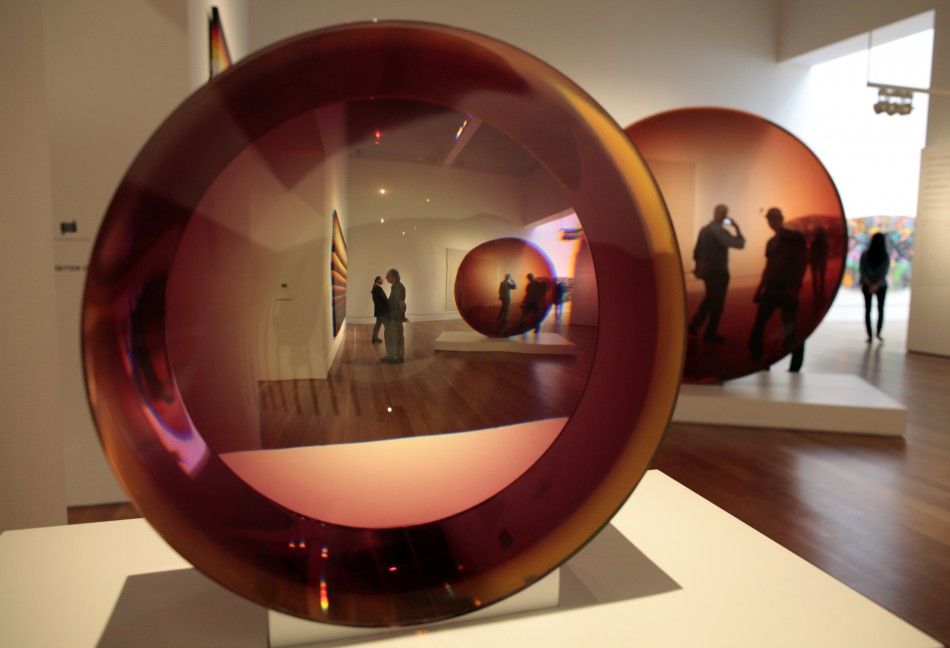 In an optical illusion Red Concave Circle by De Wain Valentine R is seen twice through quotUntitledquot by Frederick Eversley at the quotPacific Standard Time Art in L.A. 1945-1980quot exhibition at the Getty Center in Los Angeles, California 